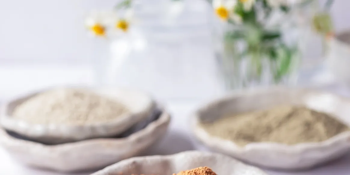 Bowls of natural clay powders for pure and detoxifying skincare formulations