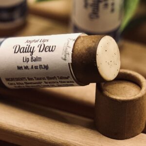 Daily Dew tallow lip balm open showing creamy natural blueberry seed oil formula inside kraft tube