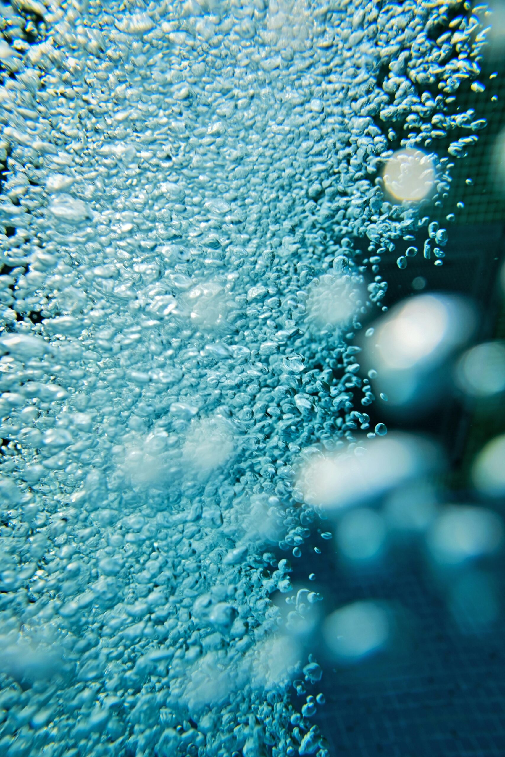 Close up of electrolysis bubbles in water representing hypochlorous acid HOCl generation process