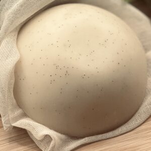 Close up of vanilla bean specks on Body Blessings Solid Lotion Bar surface
