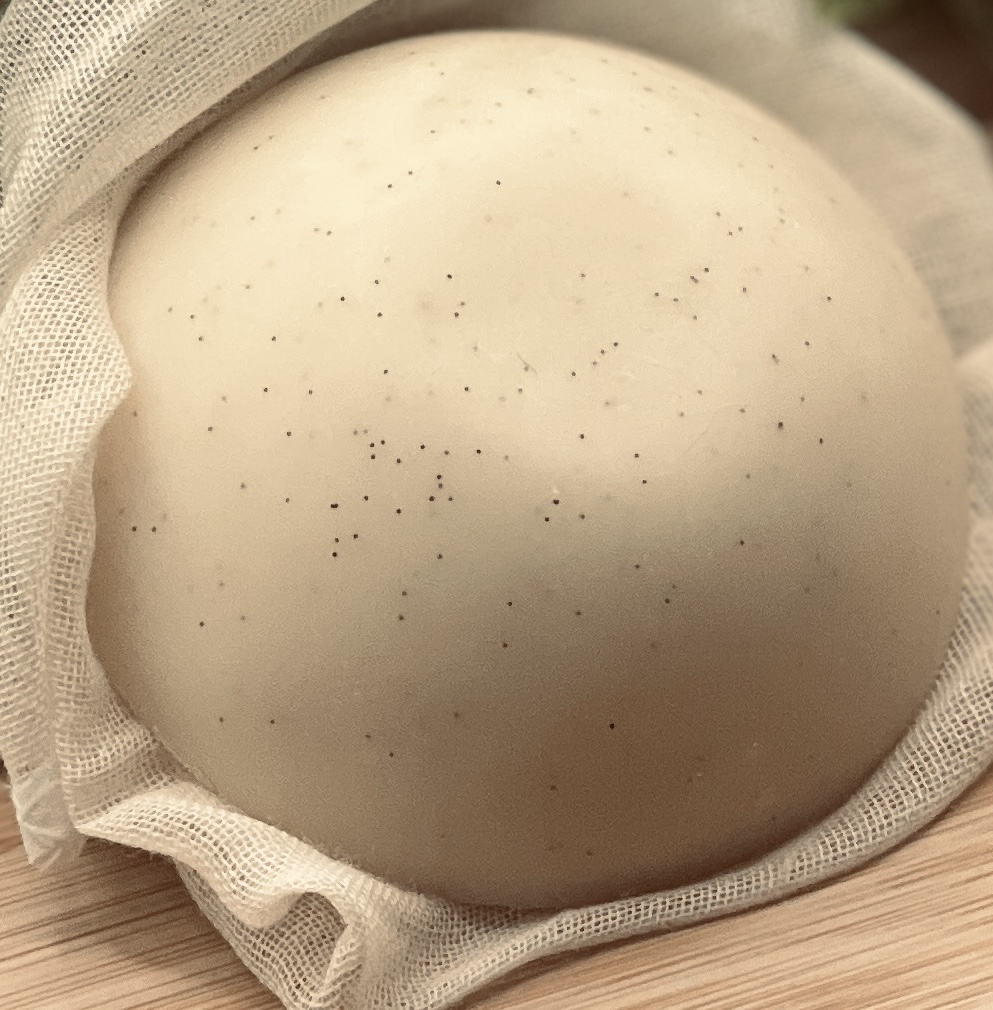 Close up of vanilla bean specks on Body Blessings Solid Lotion Bar surface